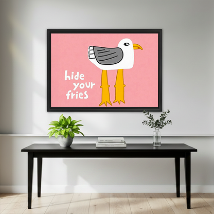 Gallery-wrap Hide Your Fries seagull canvas wall art with yellow legs above a wooden console.