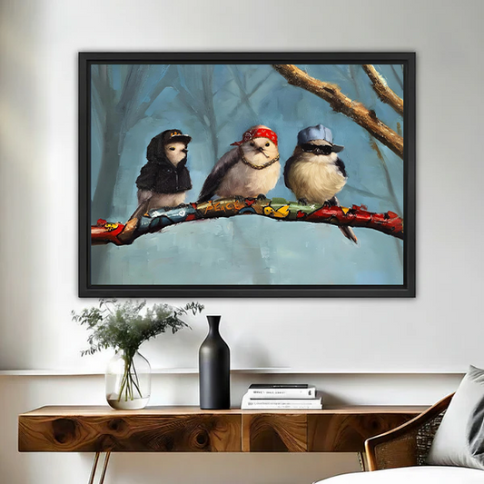 Framed hip-hop birds wall art print of three stylish birds in caps and sunglasses on a branch, hung above a wooden console table