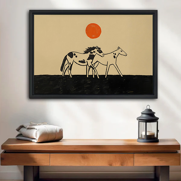 Horse pair canvas wall art above a wooden console, showing two stylized horses beneath an orange sun