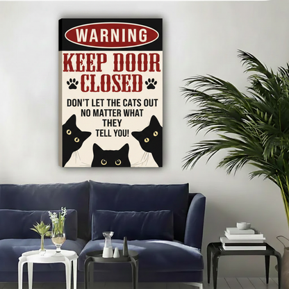 Three peeking black cats keep door closed don't let cats out float frame canvas wall art above navy blue sofa in contemporary living room