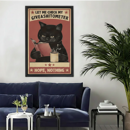 Grumpy black cat reading book coffee mug giveashitometer wall art print in black frame above navy blue sofa with palm plant in modern living room