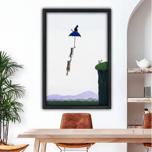 Surreal framed canvas print of three cats flying with a blue umbrella over mountain cliffs – whimsical cat wall art