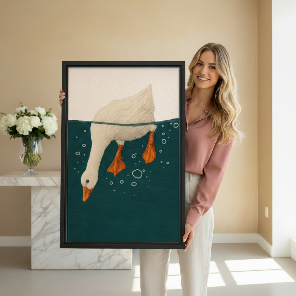 Smiling woman holding framed white goose diving art print in bright beige room with white floral arrangement