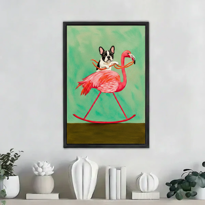 Funny French bulldog riding pink flamingo rocking horse wall art print in black frame on white shelf with white ceramic vases and green plants