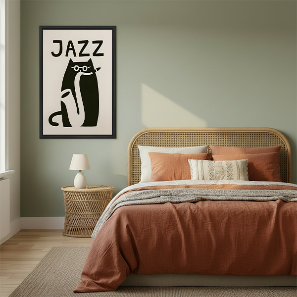 Framed jazz cat canvas wall art with a warm ivory background beside a rattan bed and rust-colored bedding.