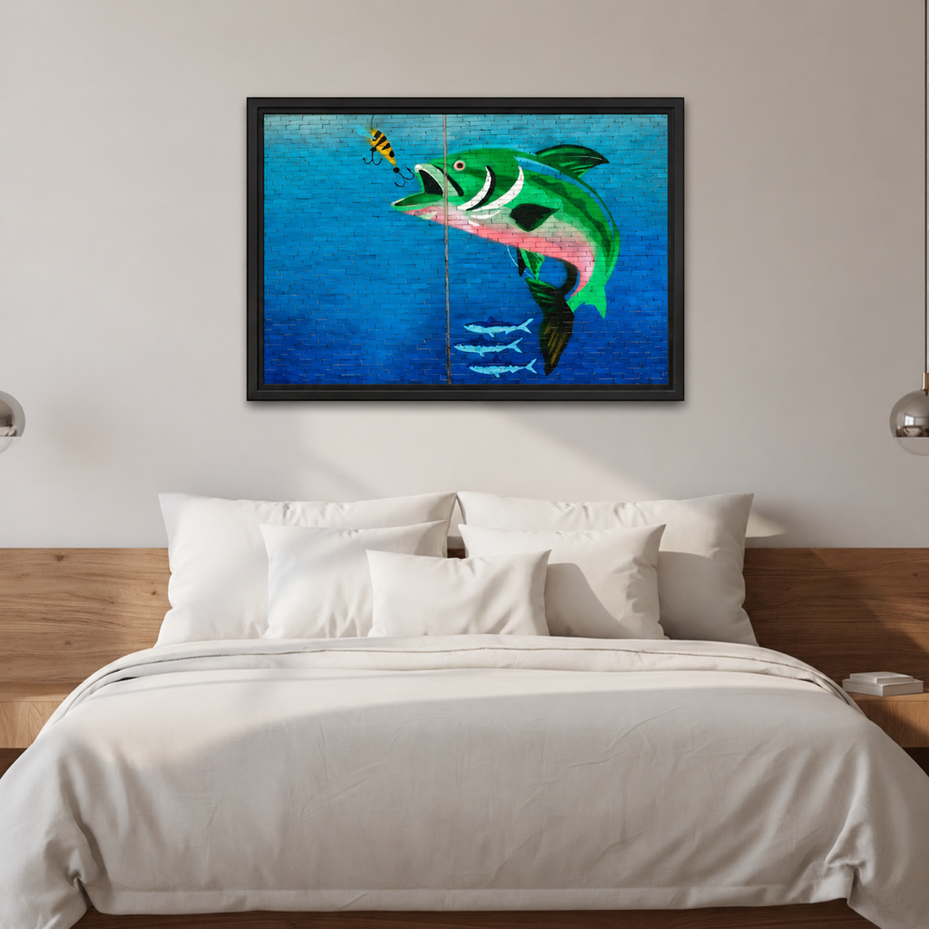 Framed bass fishing canvas wall art hangs above a white bed between two pendant lights.