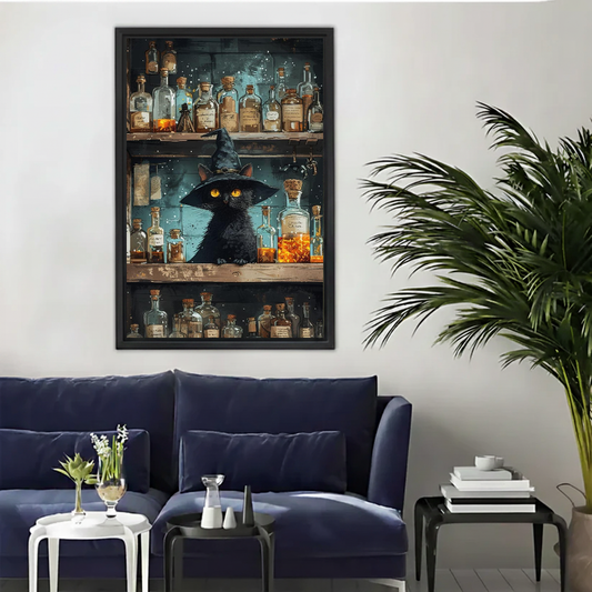 Vintage witch potion cat canvas wall art framed above a navy sofa beside a tall indoor palm.