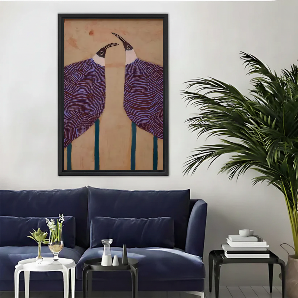 Graphic purple birds canvas wall art framed above a navy sofa beside a tall indoor palm.