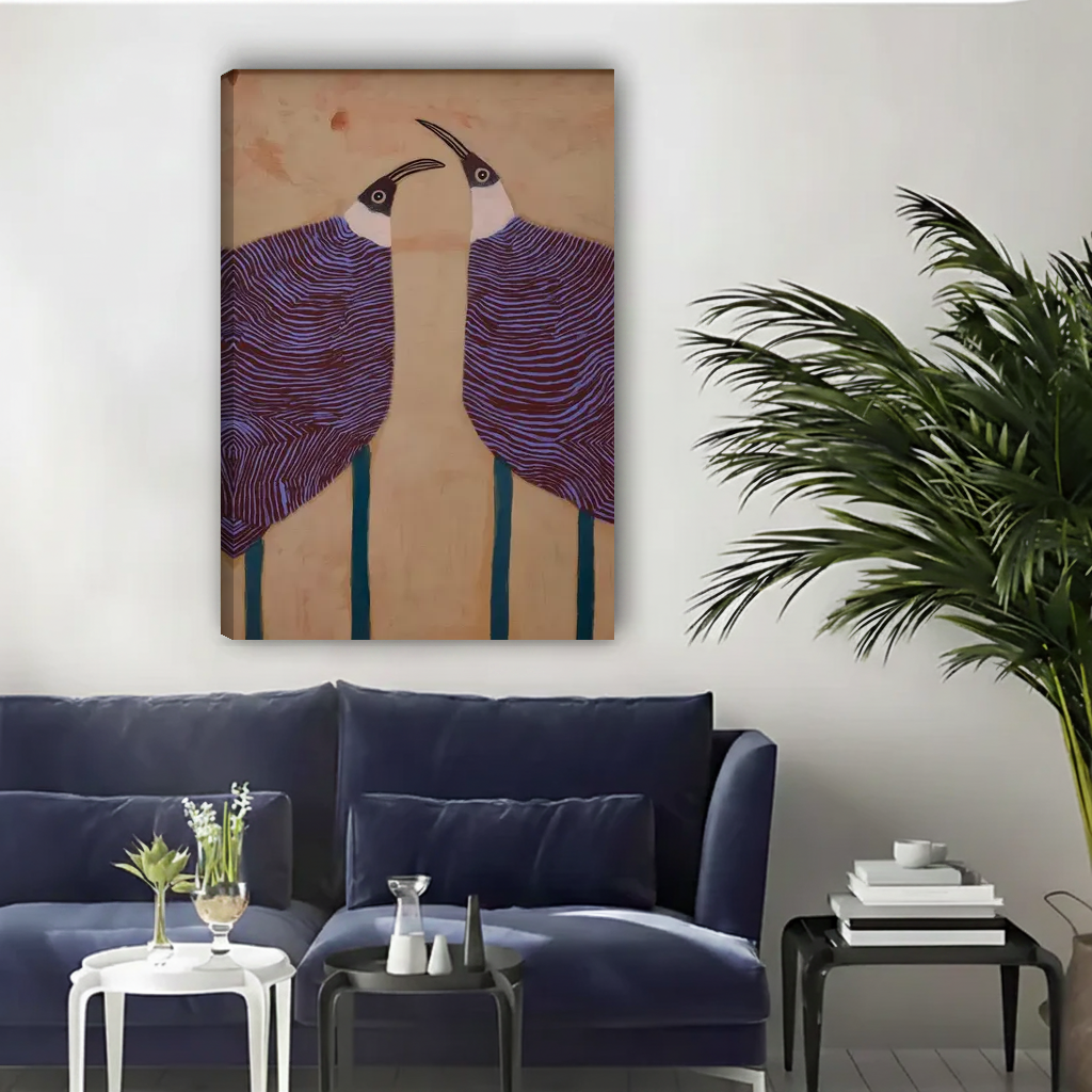 Graphic purple birds canvas wall art unframed above a navy sofa in a bright living room.