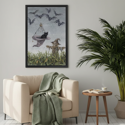 Whimsical flying cat canvas wall art framed above a cream armchair with a green knitted blanket.
