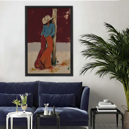 Rustic cowboy rest canvas wall art framed above a navy sofa beside a tall indoor palm.