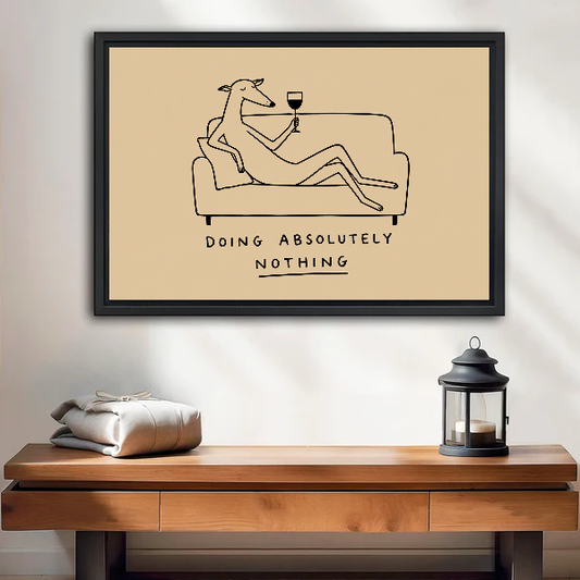 Relaxing wine dog canvas wall art framed above a wooden console beside a lantern and folded blanket.