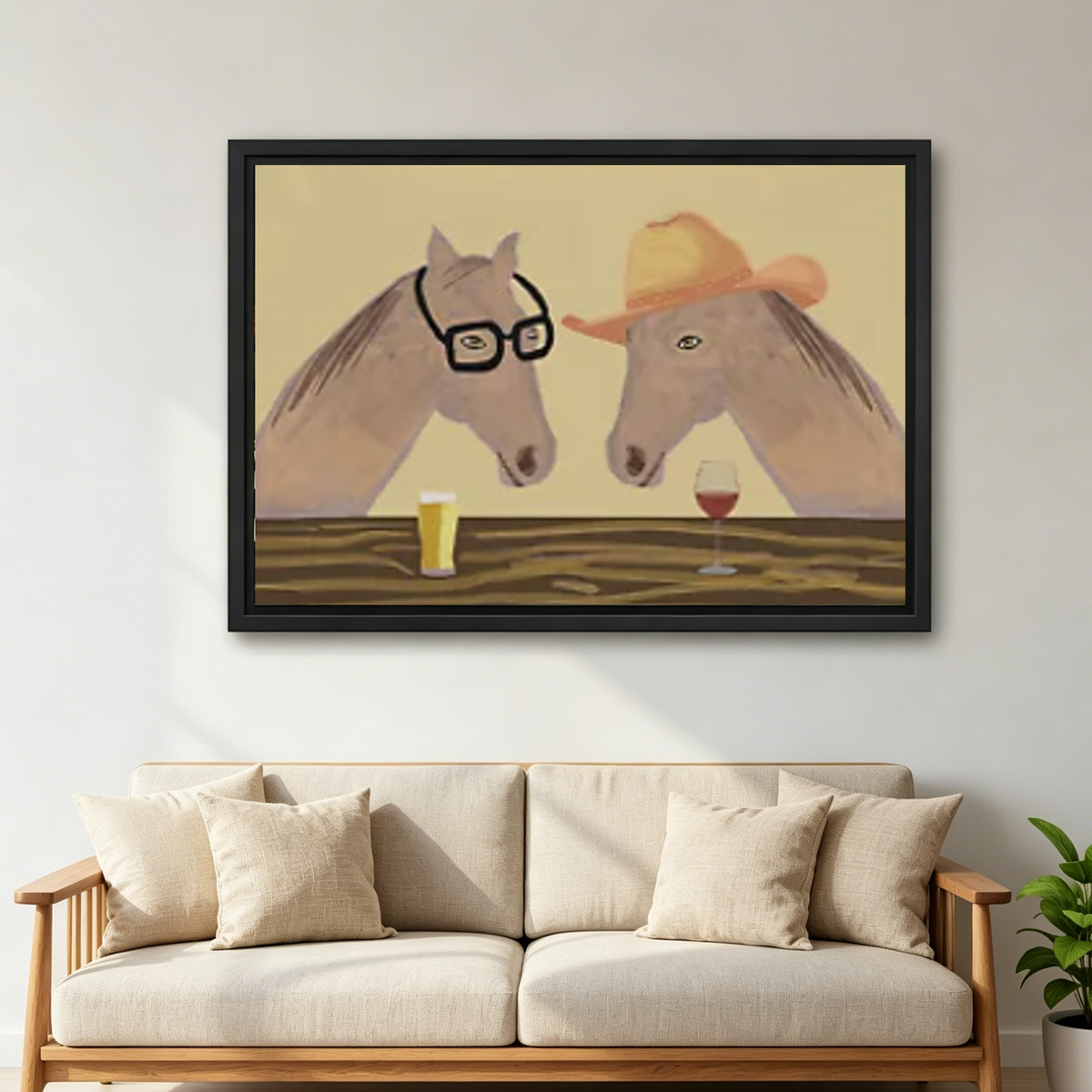 Whimsical horse wine canvas wall art framed above a cream sofa with cushions in a neutral living room.