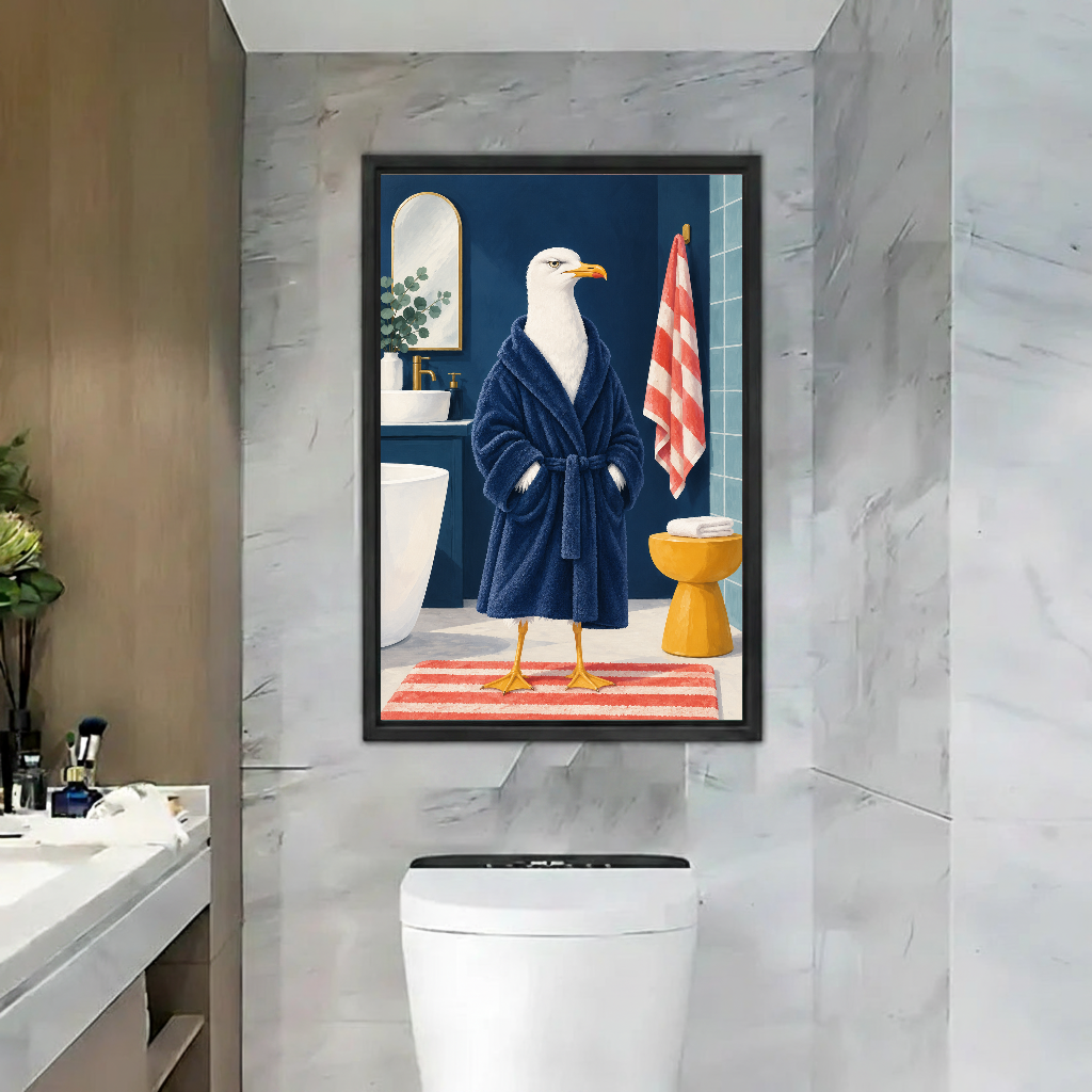 Funny bathrobe seagull canvas wall art framed above a toilet against pale marble bathroom tiles.