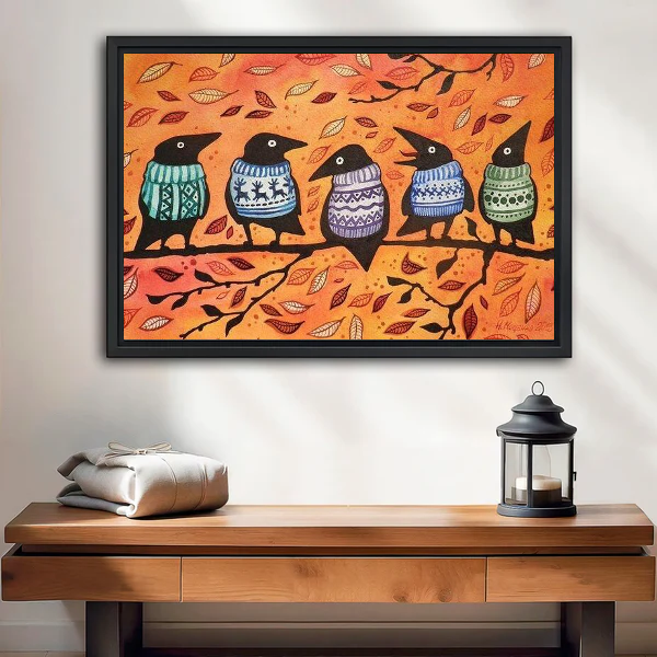 Autumn Sweater Crows canvas art framed above a wooden table and lantern.