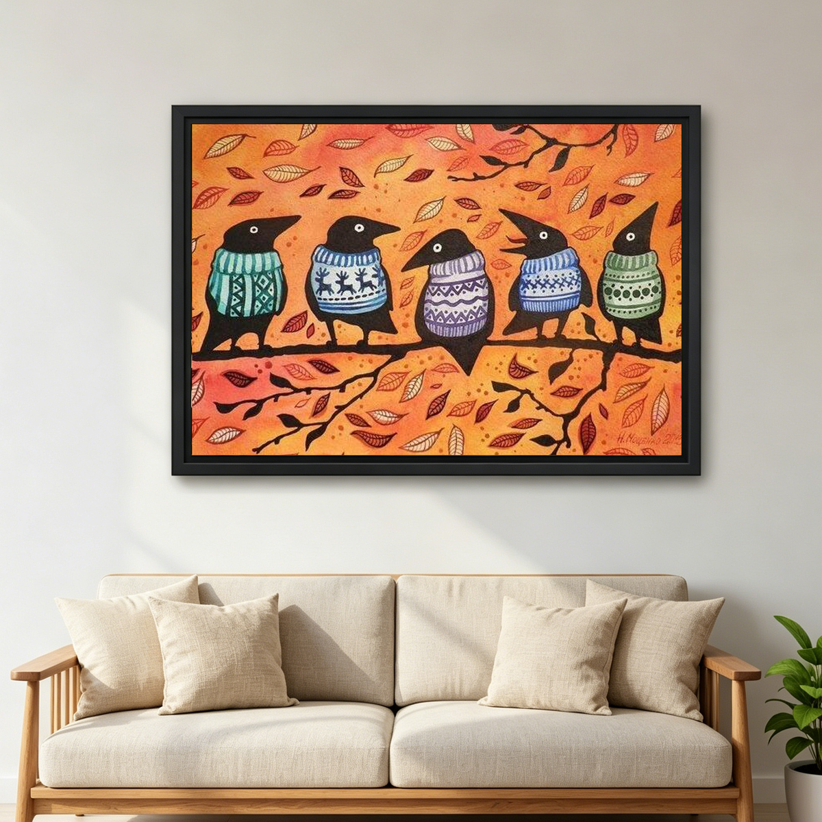 Autumn Sweater Crows canvas art framed above a cream sofa with wooden arms.