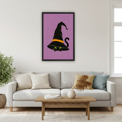 Whimsical Witch Hat Cat artwork in a black frame above a cream sofa beside a window.