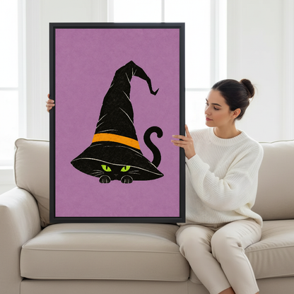 Whimsical Witch Hat Cat artwork displayed beside a seated woman in a neutral interior.