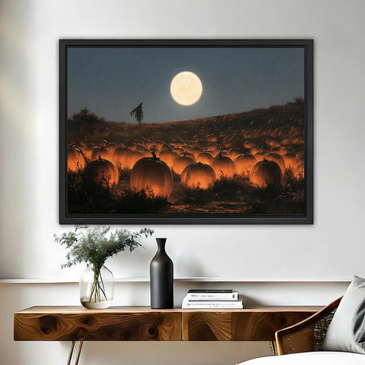 Moonlit Glowing Pumpkin Field artwork in a black frame above a live-edge wooden desk.