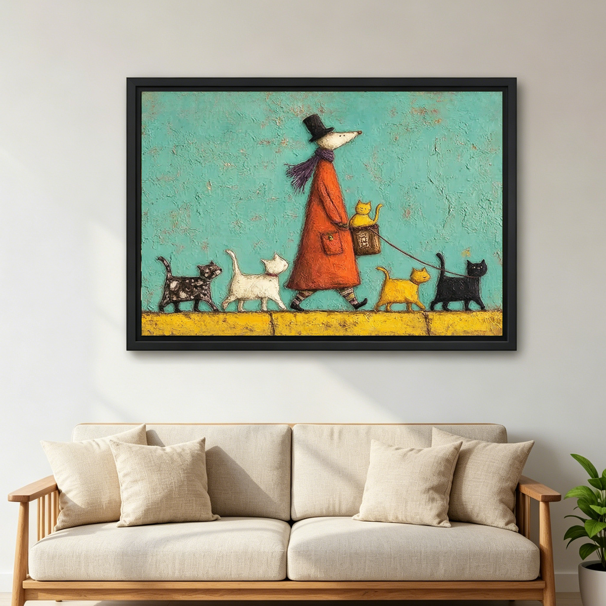 Whimsical cat walk canvas wall art in a black frame above a cream sofa with wooden arms.