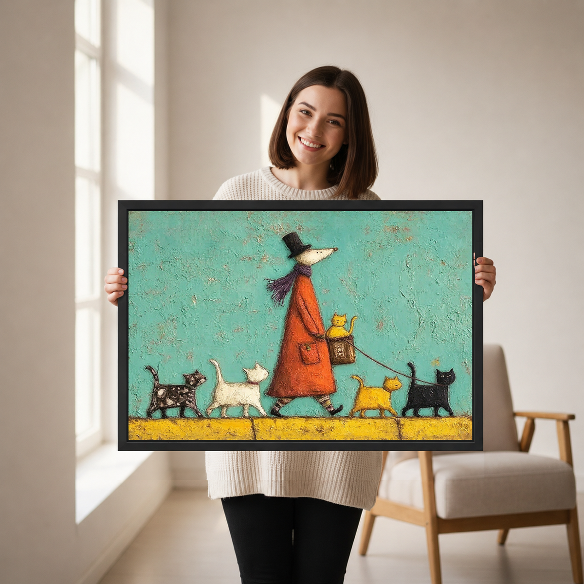 Woman holding framed whimsical cat walk canvas wall art in a softly lit neutral living room.