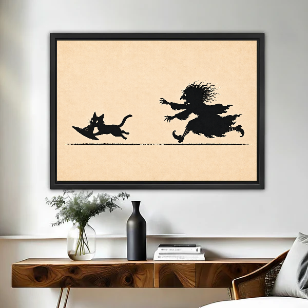 Funny Witch Cat Chase artwork in a black frame above a live-edge wooden desk.