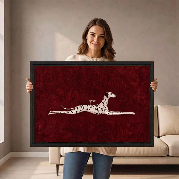 Surreal Dalmatian Cocktail artwork held in a black frame by a woman beside a cream sofa.