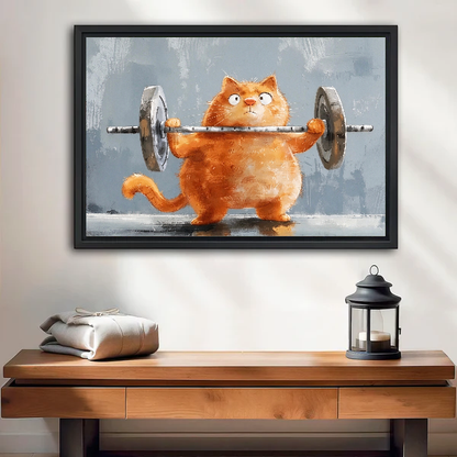 Weightlifting cat canvas wall art displayed in a black frame above a wooden table and lantern.