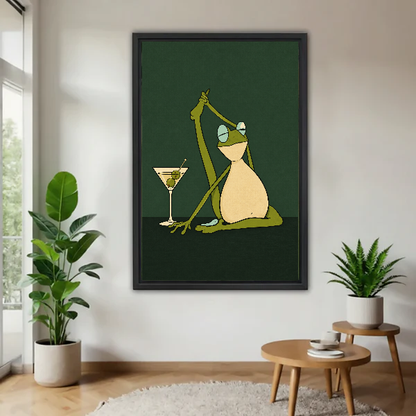Funny Yoga Martini Frog artwork in a black frame beside green plants and a wooden table.