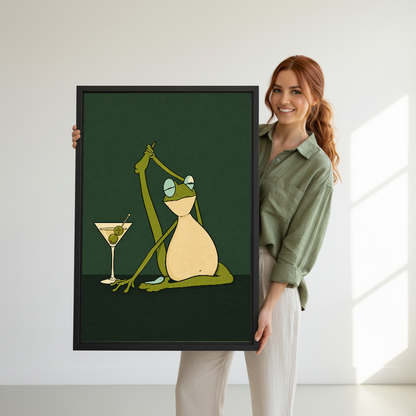 Funny Yoga Martini Frog artwork held by a woman in sage beside a bright window.