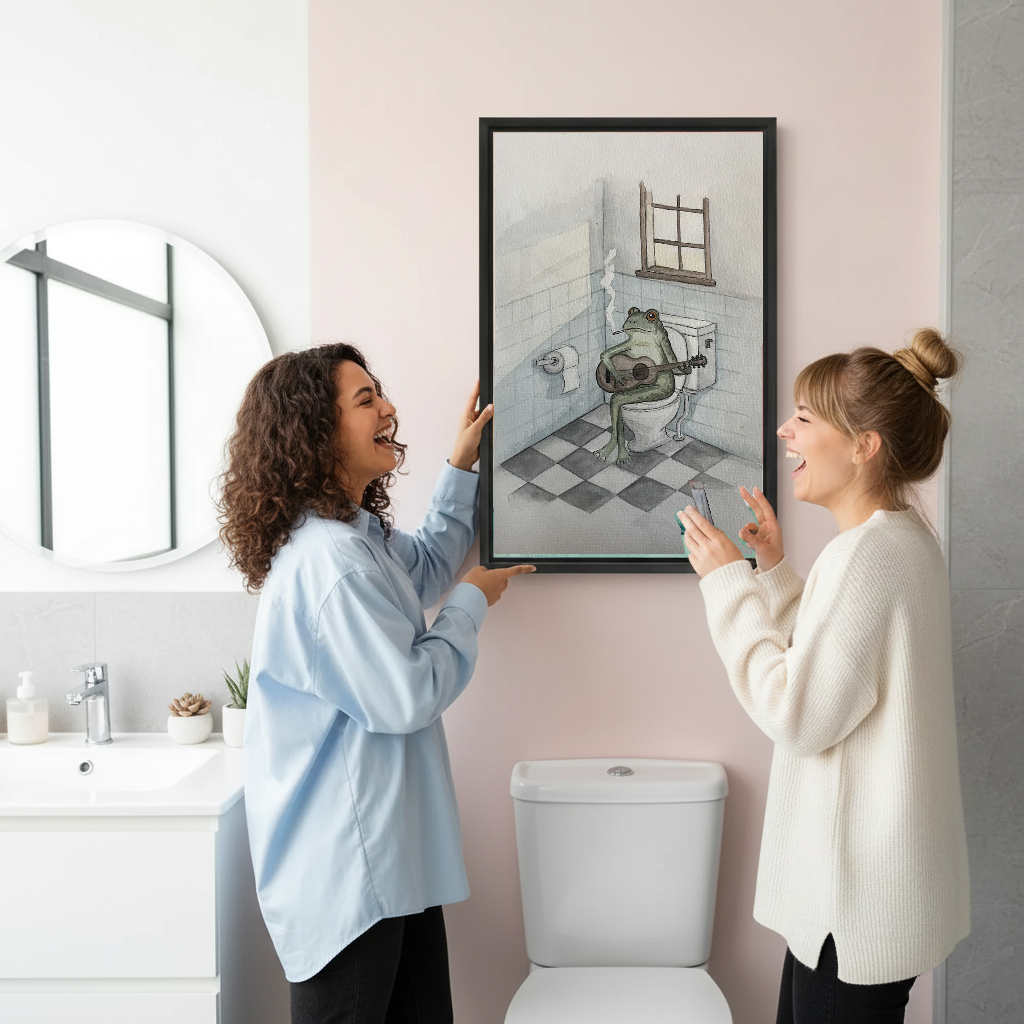 Funny Guitar Bathroom Frog artwork held in a black frame by women in a bright bathroom.