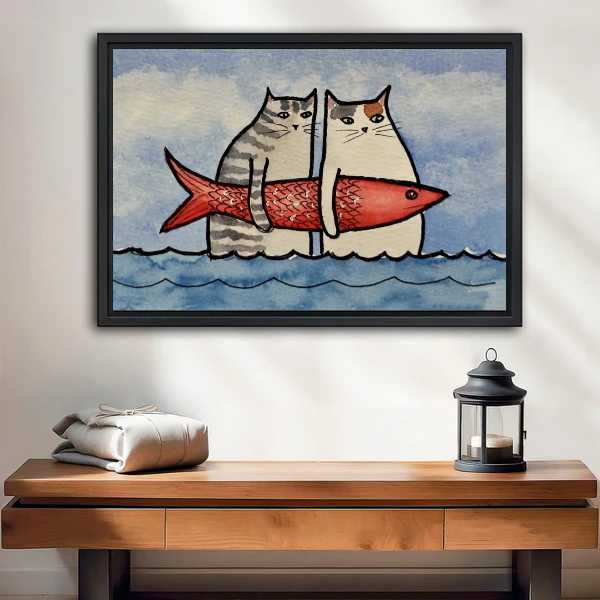 Funny Cats Red Fish artwork in a black frame above a wooden table and lantern.