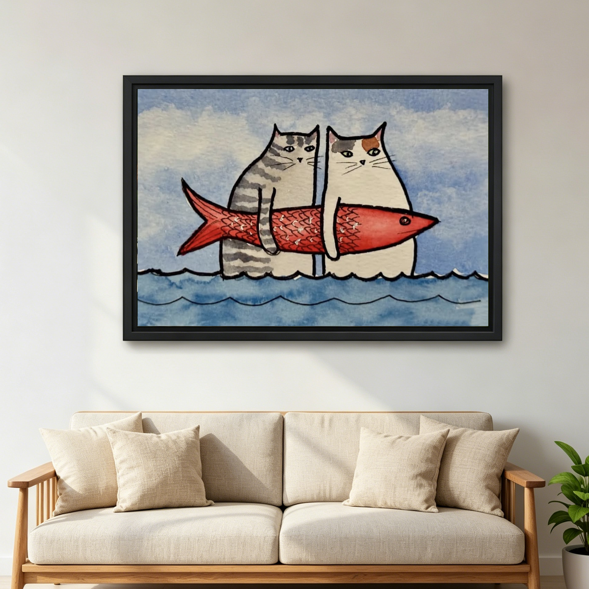 Funny Cats Red Fish artwork in a black frame above a cream sofa with wooden arms.
