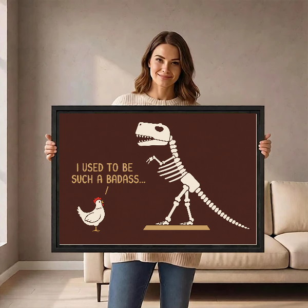 Funny Dinosaur Chicken artwork held in a black frame by a woman beside a cream sofa.