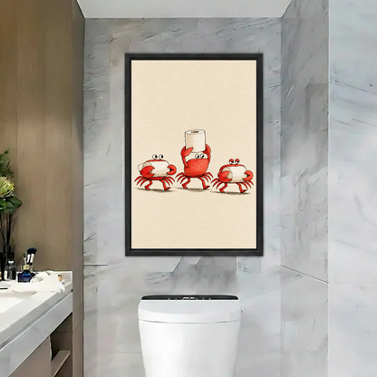 Funny Toilet Paper Crabs artwork in a black frame above a toilet beside a bathroom basin.