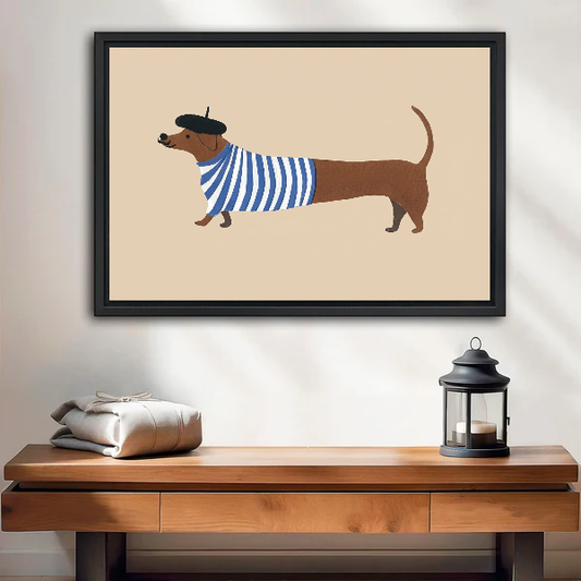French Striped Dachshund artwork in a black frame above a wooden table and lantern.