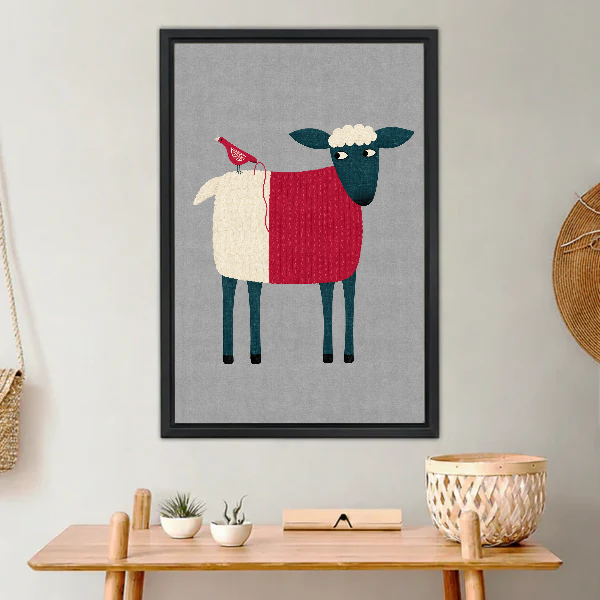 Folk Sheep Red Bird artwork in a black frame above a warm wooden console.