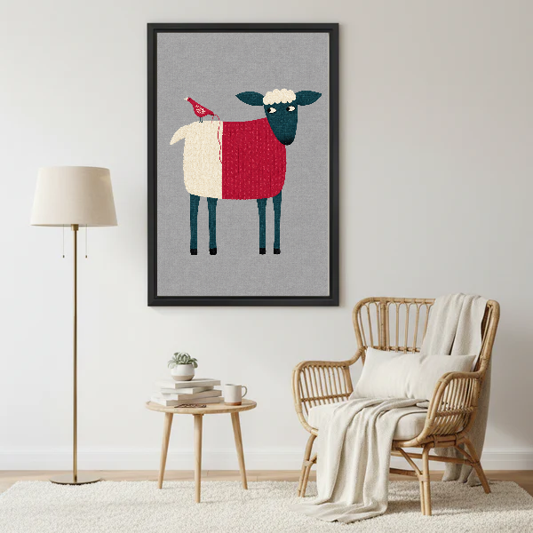 Folk Sheep Red Bird artwork in a black frame beside a lamp and pale rattan chair.