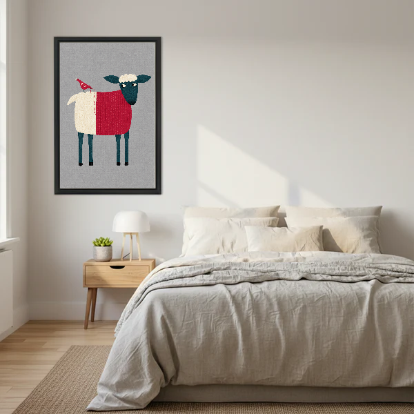 Folk Sheep Red Bird artwork in a black frame above a bed with cream bedding.