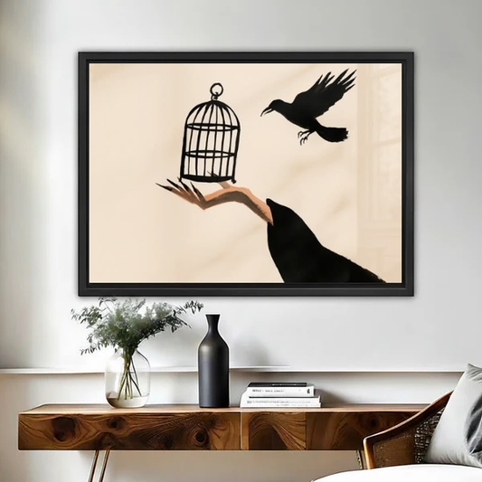 Raven Hand Birdcage artwork in a black frame above a live-edge wooden desk.