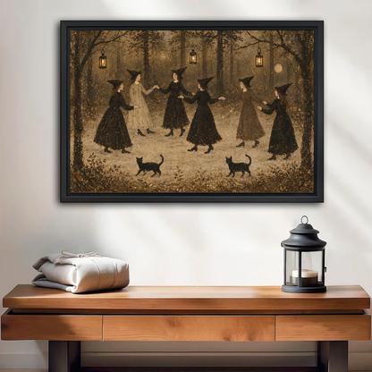 vintage dancing witches canvas wall art framed above a wooden table with lantern and folded blankets.
