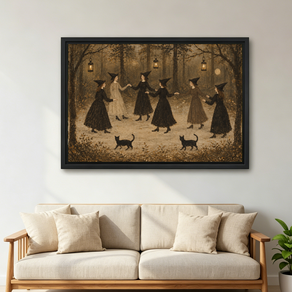 vintage dancing witches canvas wall art framed above a cream sofa with wooden arms and green plant.