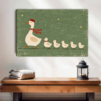 whimsical goose family canvas wall art unframed above a wooden table with lantern and folded blankets.