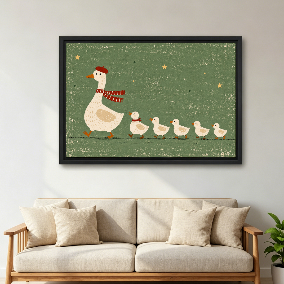 whimsical goose family canvas wall art framed above a cream sofa with wooden arms and green plant.