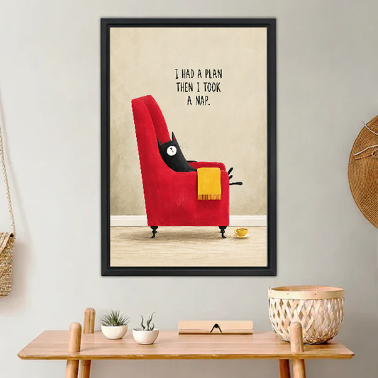 funny napping cat canvas wall art framed above a light wood console with cacti and basket.