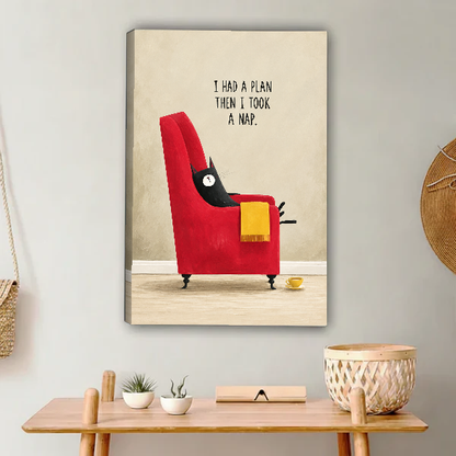 funny napping cat canvas wall art unframed above a light wood console with cacti and basket.