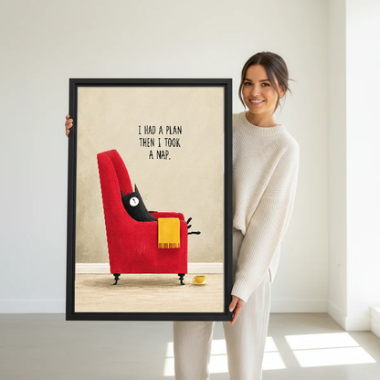 funny napping cat canvas wall art framed as a woman dressed in white holds the artwork.
