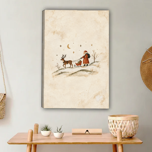 minimalist santa sleigh canvas wall art unframed above a light wood console with cacti and basket.
