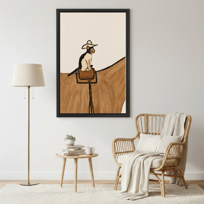cowboy saddle cat canvas wall art framed beside a wicker armchair with floor lamp and small table.
