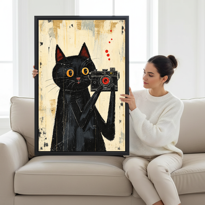 vintage camera cat canvas wall art framed as a seated woman holds the artwork on a pale sofa.
